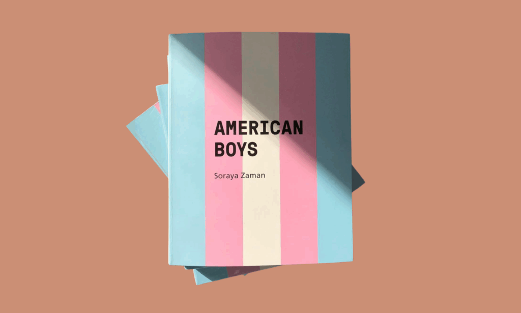 The book American Boys by Soraya Zaman, featuring Dominic Pérignon, displayed with its trans flag–inspired cover against a warm brown background.